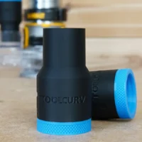 Black plastic hose adapter with blue knurled grip rings at each end, labeled ToolCurve, shown on wooden surface with tools in background