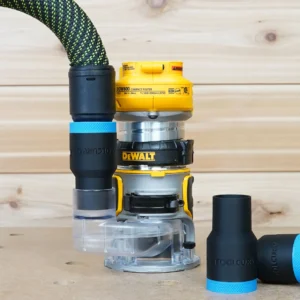 Black ToolCurve hose adapter with blue band joining a green vacuum hose to a DeWalt DCW600 trim router, plus two loose adapters