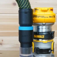 Blue hose adapter with blue band attached to DeWalt DCW600 compact router, stacked with other router collets