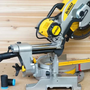 Black hose adapter with blue band joining a dust extractor hose to a DeWalt miter saw rear dust port, spare adapter alongside