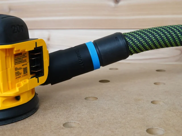 Black hose adapter with blue band attached to yellow Dewalt sander, connected to green and black braided hose