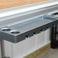 Gray aluminum utility rack with six slots for clamps and two holes for bench dogs, mounted on a Festool MFT workbench t-track