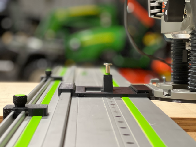 Bosch 1617 plunge router adapter mounted on Festool track rails with LR 32 plate, spring-loaded knob, and guide stops installed