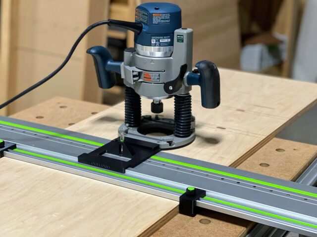 Bosch 1617 plunge router mounted on LR 32 rail adapter with black mounting plate, positioned over Festool track saw rail on wooden workbench