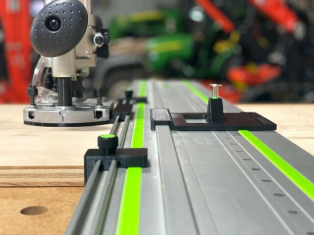 Makita plunge router mounted on Festool FS rails with ToolCurve LR32 adapter plate and guide stops, showing drilling setup from above