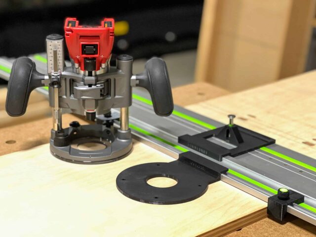 Milwaukee plunge router on LR32 rail adapter with black hole drilling plate, guide stops, and spring-loaded knob on wooden workbench