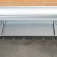 Aluminum utility rack with central tray and four mounting holes for clamps, mounted on workbench t-track