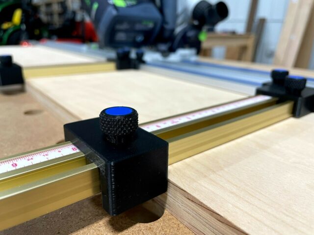 Black 3D-printed parallel guide bracket mounted on Kreg guide rail with blue knurled adjustment knob and measurement scale visible