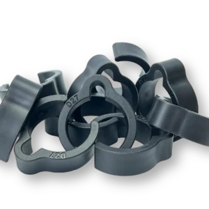 Loose pile of dark gray 27mm coiled hose clips with D27 marking molded into the C-shaped bodies