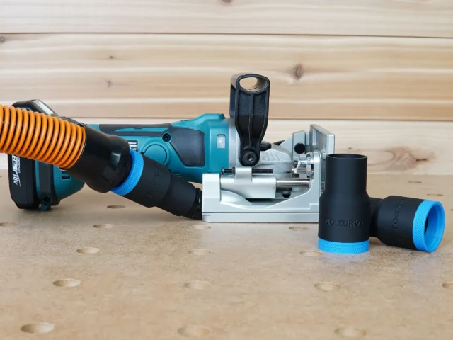 Black 1-1/4" hose adapter with blue collar on a Makita plate joiner, orange hose attached, spare adapters beside