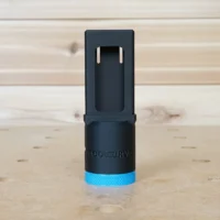 Black hose adapter with blue grip ring for Kreg 720 pocket-hole jig, shown standing upright with two mounting tabs visible at top