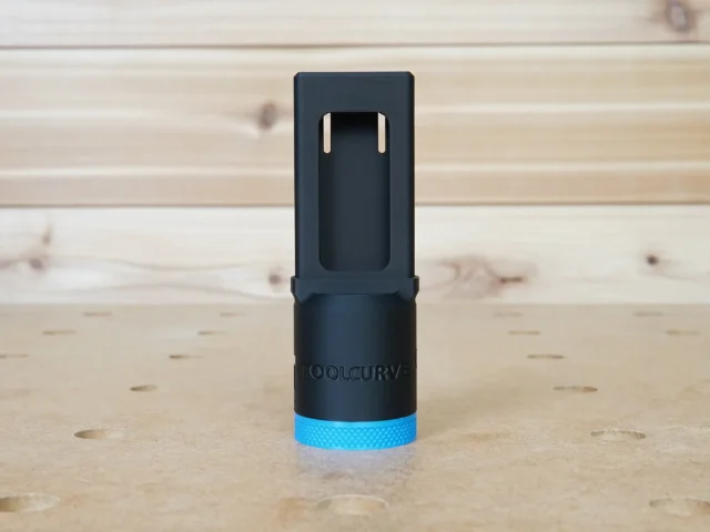 Black hose adapter with blue grip ring for Kreg 720 pocket-hole jig, shown standing upright with two mounting tabs visible at top