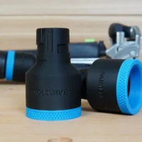 Black ToolCurve hose adapter with blue grip bands, shown front and side view with Festool hoses connected in background