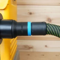 Black hose adapter with blue band attached to Dewalt 734 planer, connected to green and black braided Festool hose
