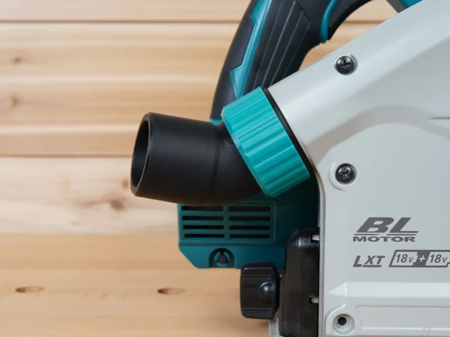 ToolCurve No Snag Dust Port attached to a Makita track saw, with black hose routed upward through the turquoise adapter