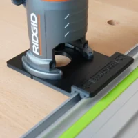 Ridgid trim router mounted on a black ToolCurve adapter attached to a Kreg guide rail