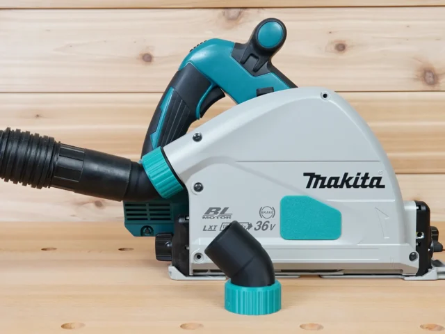 ToolCurve No-Snag Dust Port adapter attached to a Makita track saw, angling the black hose upward away from the cutting area