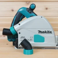 ToolCurve No-Snag Dust Port Adapter attached to a Makita track saw with turquoise hose connector installed