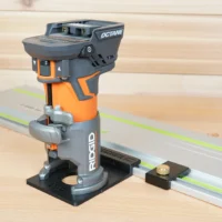Ridgid trim router mounted on FS rail adapter, positioned over a Festool-style guide rail on wood