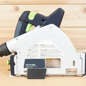 Black arbor dust cover snapped onto the side of a Festool TSC 55 REB track saw, side view