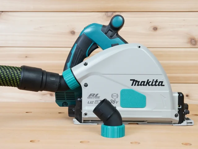 ToolCurve No-Snag Dust Port adapter installed on a Makita track saw, with hose attached showing upward-angled port design