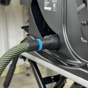 Black ToolCurve hose adapter with blue band joining a green-black hose to a SawStop jobsite saw dust port