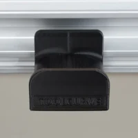 Black ToolCurve headphone holder clipped to Festool MFT/3 table t-track, front view showing dual compartments and branded nameplate
