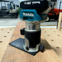 ToolCurve extended base plate mounted on Makita trim router, showing black PETG plate extending from router base