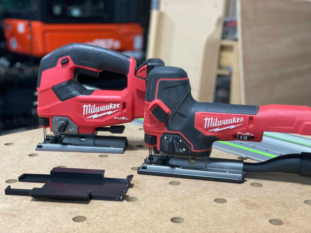 Milwaukee M18 jig saw adapter plates in black, displayed next to two Milwaukee jig saws on a workbench with guide rails