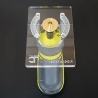 Clear 6x4 inch base plate on a Ryobi trim router, top view showing brass center bushing, four screws, and etched logo