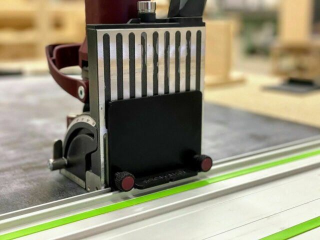 ZetaRail adapter mounted on a Festool guide rail, showing slotted connection and red knurled adjustment knobs
