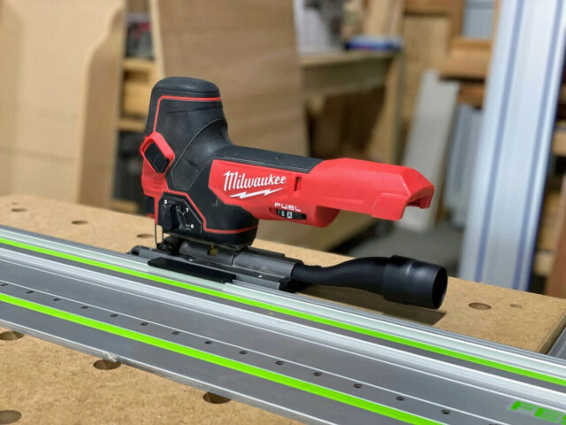 Milwaukee M18 jig saw with ToolCurve rail adapter mounted on a Festool track rail with green stripe