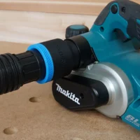 Black and blue hose adapter with ToolCurve branding connected to dust port on turquoise Makita hand planer