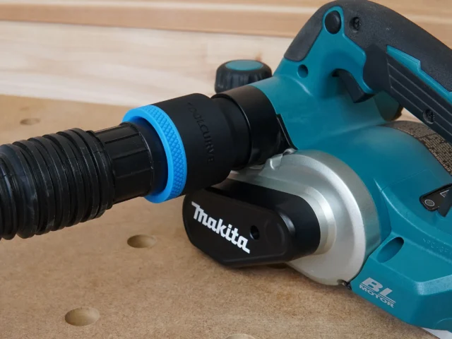 Black and blue hose adapter with ToolCurve branding connected to dust port on turquoise Makita hand planer