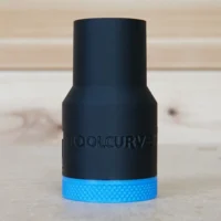 Black hose adapter with blue grip band for Dewalt DW618 router, shown standalone on wood surface