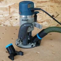 Hose adapter for Bosch 1617 plunge router mounted on blue Bosch router base with green Festool hose attached and adapter end piece shown separately