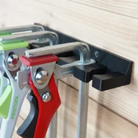 Quick Clamp Wall Mount Rack attached to Festool rail, holding four clamps with green and red handles
