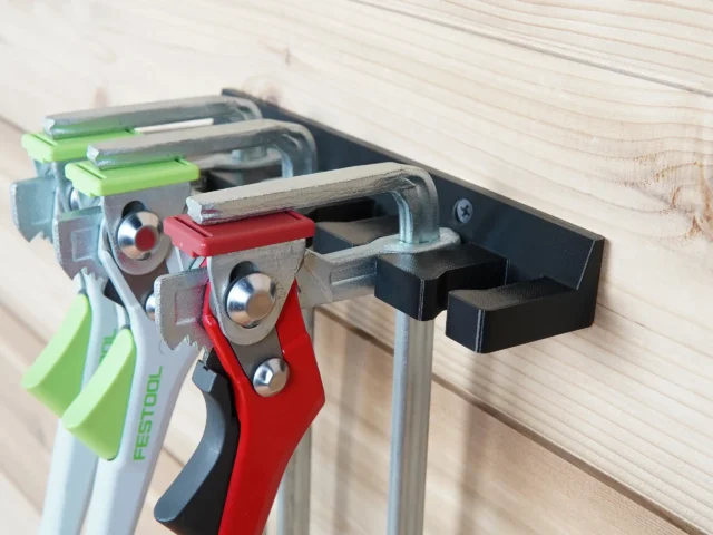 Quick Clamp Wall Mount Rack attached to Festool rail, holding four clamps with green and red handles