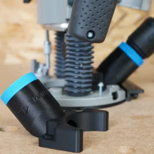 Black angled ToolCurve hose adapter with blue collar in foreground, plunge router with hose connected behind