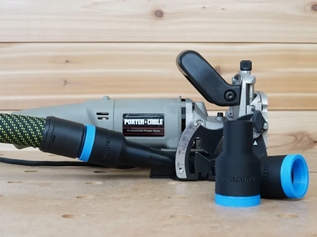 Black and blue hose adapter attached to a Porter Cable 557 plate joiner, with a dust extractor hose connected to the adapter port