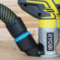 Hose adapter attached to Ryobi trim router with 36mm hose connected, blue band visible on black adapter sleeve