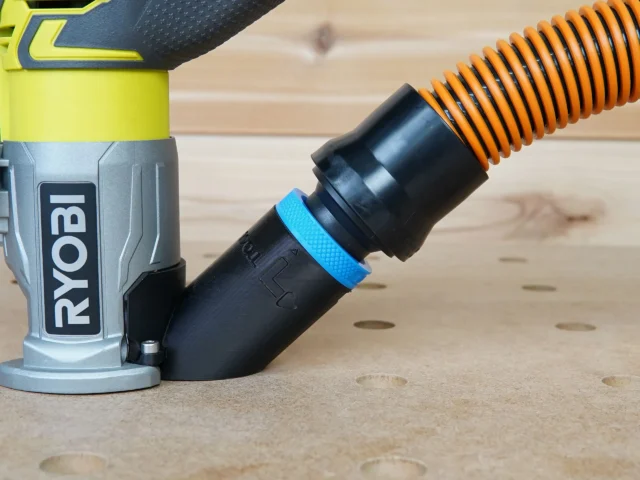 Black hose adapter with blue grip band attached to Ryobi trim router, orange hose connected to adapter port