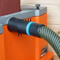 Black 36mm hose adapter with blue band joining a braided extractor hose to the orange Ridgid edge sander's dust port