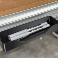 Black plastic pencil and storage tray mounted on Festool MFT/3 table t-track, holding pens and markers