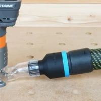 Hose adapter with blue band connected to Ridgid trim router dust port, with Festool hose attached