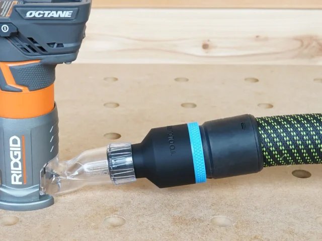 Hose adapter with blue band connected to Ridgid trim router dust port, with Festool hose attached