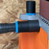 Black hose adapter with blue band attached to Ridgid oscillating edge sander dust port