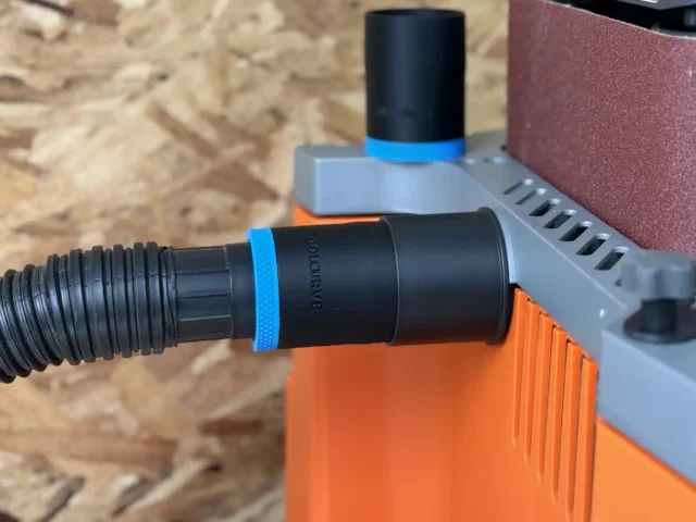 Black hose adapter with blue band attached to Ridgid oscillating edge sander dust port