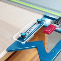 TSO guide rail support tab attached to blue aluminum guide rail square mounted on Festool track saw rail, red tab visible with thumb screw attachment