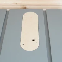 Cream-colored zero clearance insert seated in gray table saw top, showing central blade opening and mounting holes